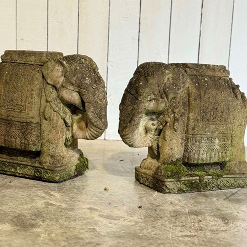 A pair of 20th century cast stone elephant planters