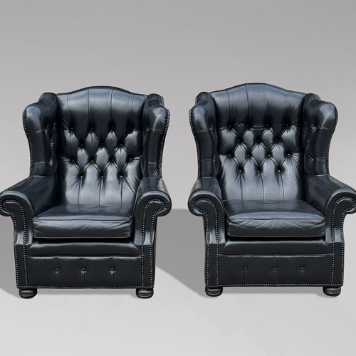 Pair Of Black Leather Wing Armchairs