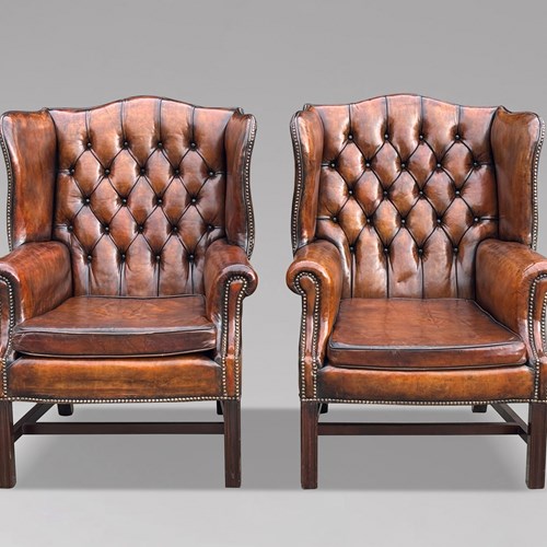 Pair Of Leather Wing Back Armchairs