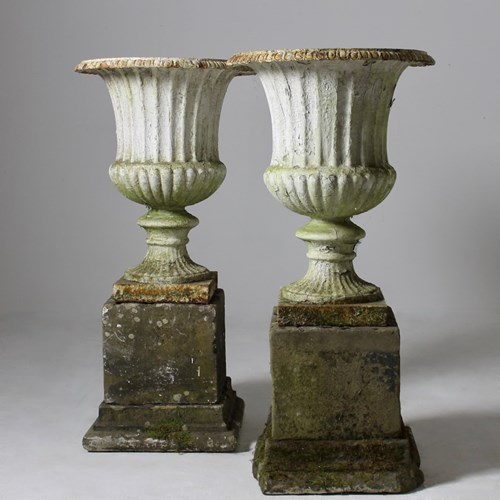 Pair Of Large Cast Iron Urns On Carved Stone Pedestals