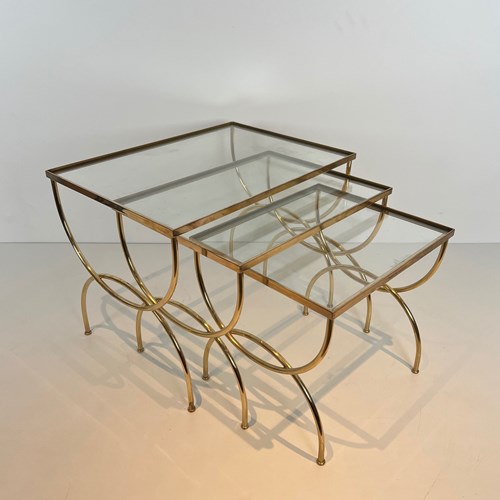 Neoclassical Style Brass Nesting Tables With Arcuate Base. 