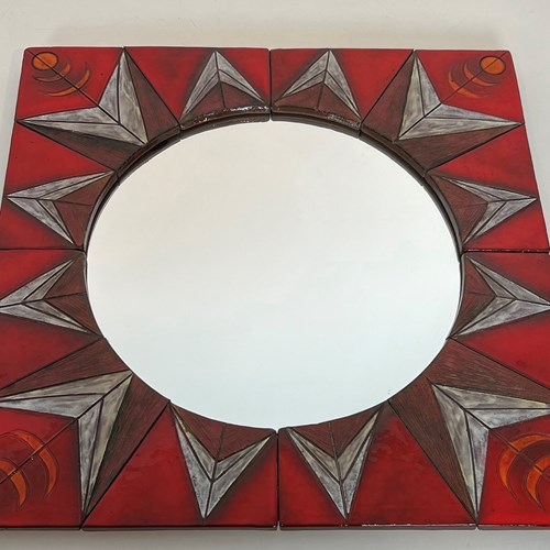 Ceramic Mirror Representing A Stylized Sun On A Red Background.