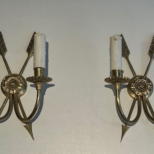 Pair Of Bronze Wall Sconces Presenting Two Crossed Arrows.