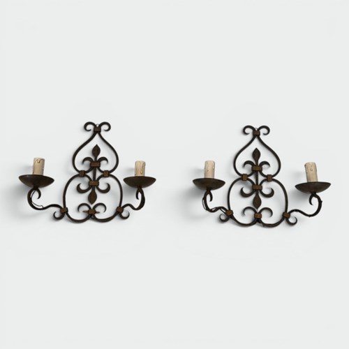Pair Of Wrought Iron Two-Light Wall Sconces With Scroll And Fleur-De-Lys Backpla