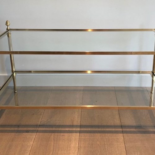 Brass Coffee Table With Two Glass Shelves Featuring Bronze Tassels On Each Corne