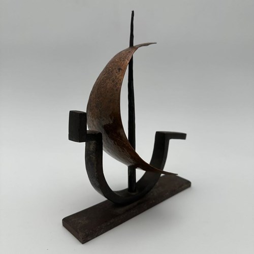 Wrought And Hammered Iron Sculpture Depicting A Stylized Sailboat Gliding Over T