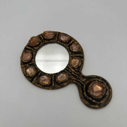 Gilt Metal Hand Mirror Featuring A Richly Textured Surface, Accented With Circul