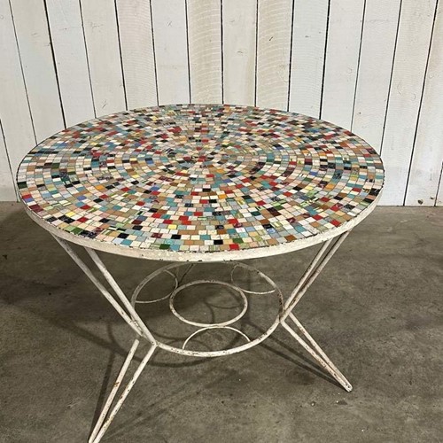 A 1960s, circular mosaic garden table