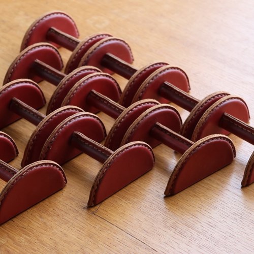 Set Of 10 Metal Objects Entirely Sheathed In Red Leather With Saddle-Stitches