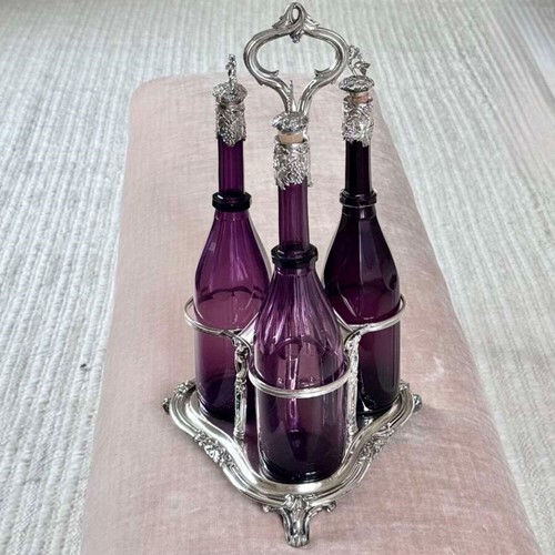 Early Victorian Triple amethyst decanters and silver plated stand dated 1839