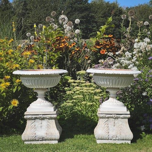 Pair Of English Victorian Cast Iron Garden Urns On Ornamented Bases