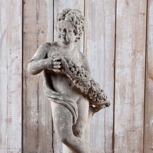 Antique limestone C19th putto statue