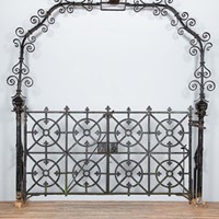 Antique pedestrian gate with arch and railing