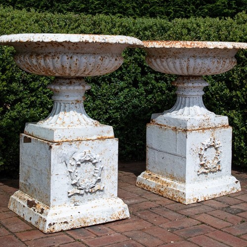 Victorian cast iron tazza urns on plinths