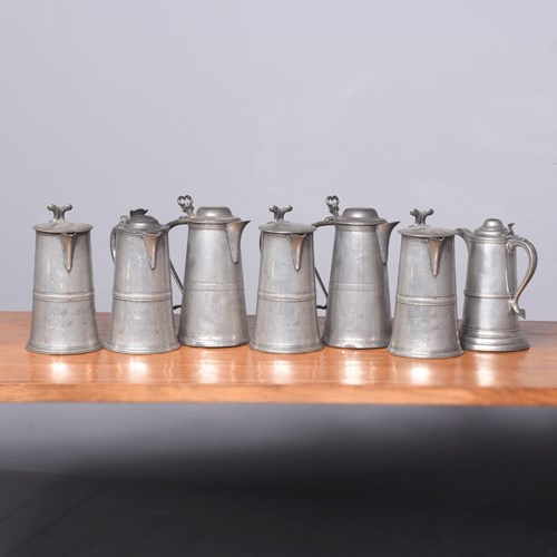 Seven Large Pewter Flagons