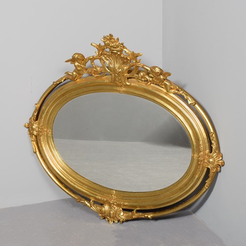 Victorian Gilt Oval Mirror With Neoclassical Putti And Foliate Decorated Pedimen