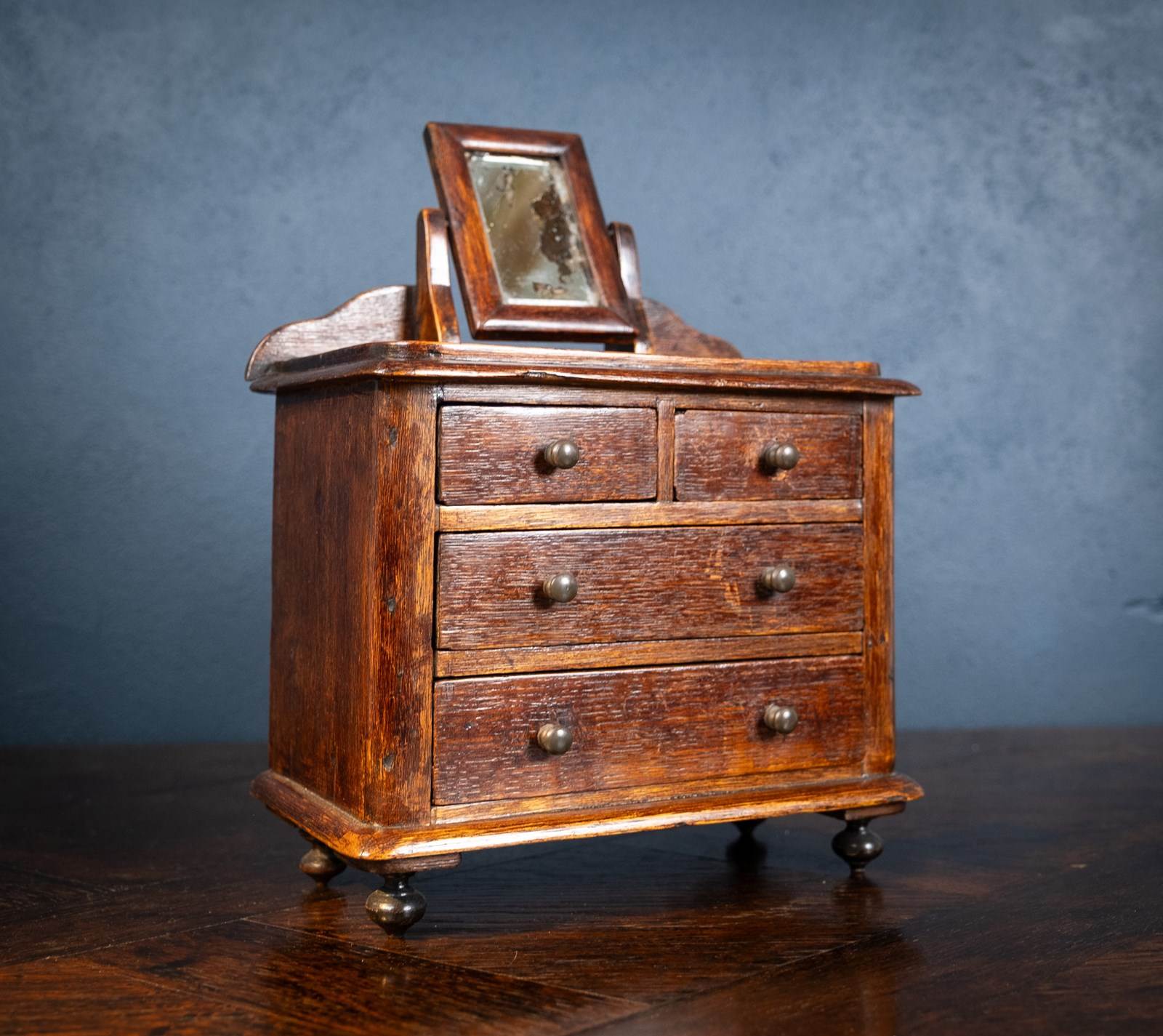 A LIMED OAK MINIATURE CHEST OF DRAWERS, LATE 19TH/EARLY 20TH