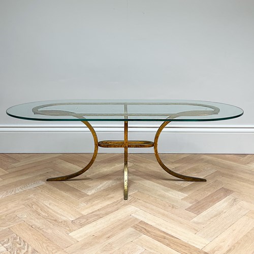An Oval Coffee Table Designed By Robert Thibier