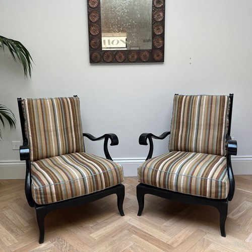A Pair Of Ebonized Armchairs
