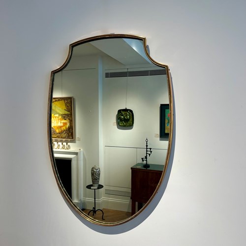 A Beaded Brass Shield Mirror