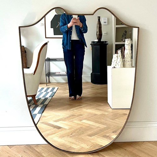 A Large Brass Shield Mirror
