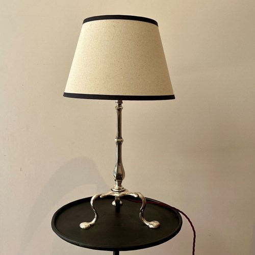 A Small Silver Coloured Tripod Lamp