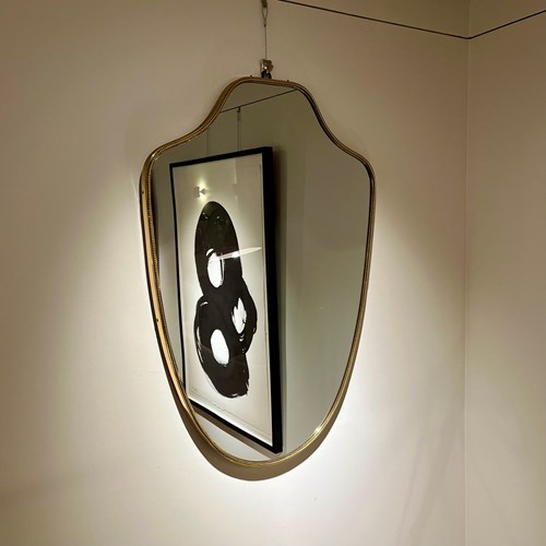 A Large Brass Shield Mirror