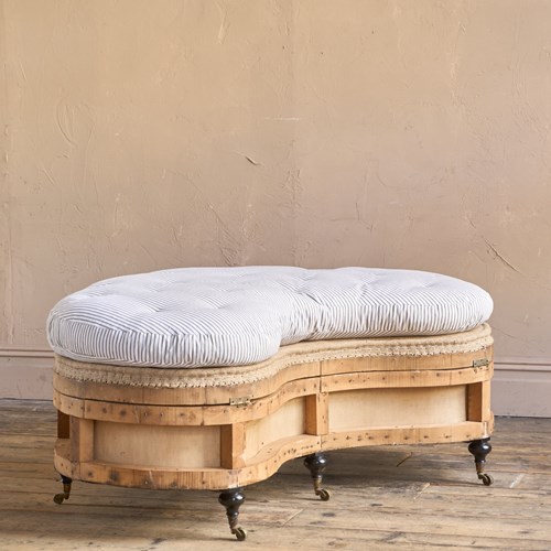 A Large Kidney Shaped Upholstered Ottoman