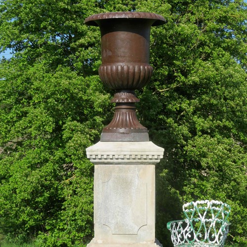 Towering cast iron urn and 19thC stone pedestal