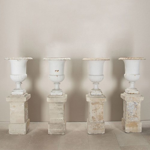 Set Of Four French Cast Iron Urns On Stone Plinths