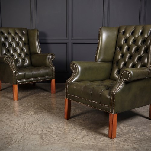 Pair Of Green Buttoned Leather Wing Chairs