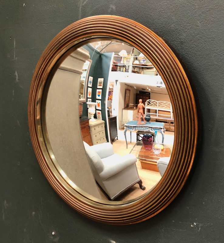 A brass framed convex mirror -marchand-antiques-091cd1cc-abf7-4009-aa67-47247c366693-main-637265329335681608.jpeg