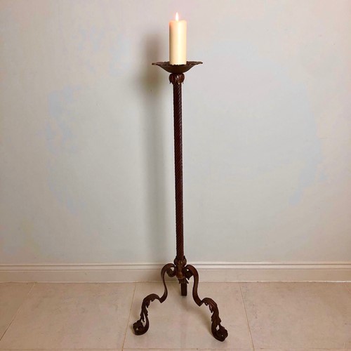 A large wrought iron candle stand 