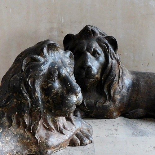 pair of recumbent cast iron lions 