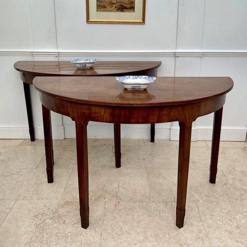 A Pair Of Mahogany Demi Lune Console Tables