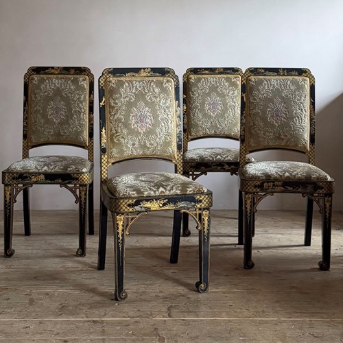 Four Black And Gold Lacquered Chinoiserie Dining Chairs.