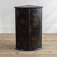 An early 18th century Japanned corner cabinet