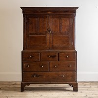 An early 19th century oak linen cupboard