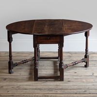 A George II 'red-walnut' drop leaf dining table