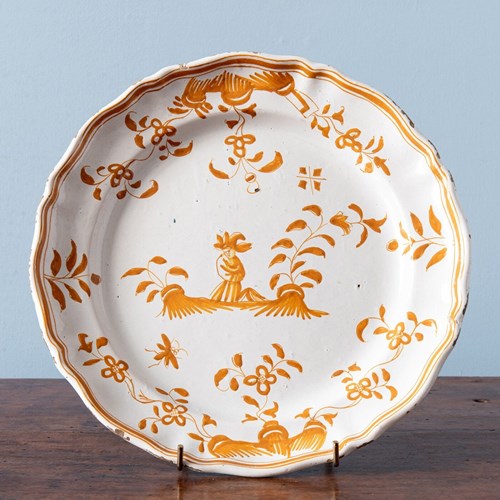 Moustiers Faience, Shaped Ochre Plate With Figure, 18Th Century