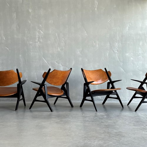 A Set Of Hans Wegner Style Leather Chairs