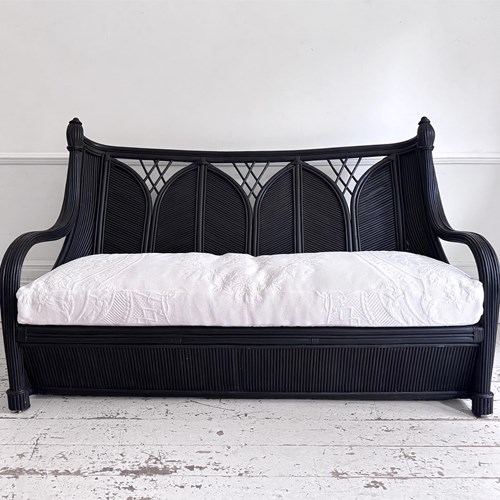 A 1950'S French Black Rattan Sculptural Sofa With Piqué Upholstery