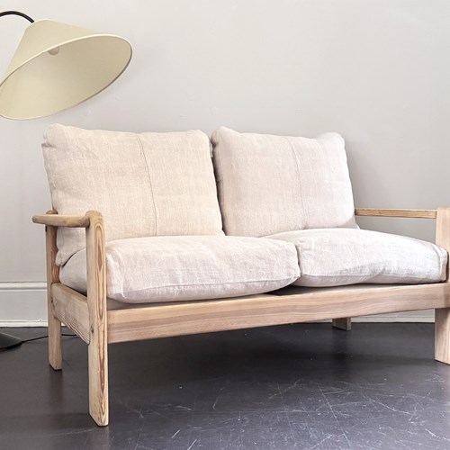 A 1970'S French Two-Seater Pine Sofas With French Linen Upholstery