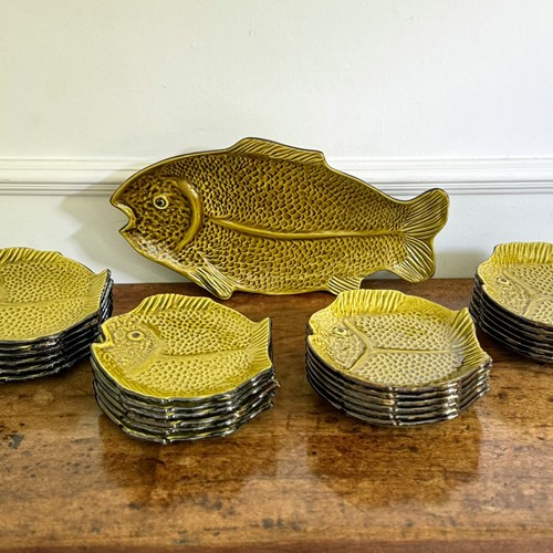 A Large Set Of Green Vallauris Style Fish Plates, Bowls & Platter