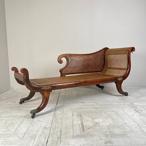 A Regency Simulated Rosewood And Cane Chaise Longue