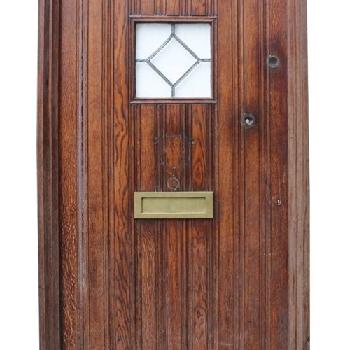 A Reclaimed Arched Oak Exterior Door With Frame