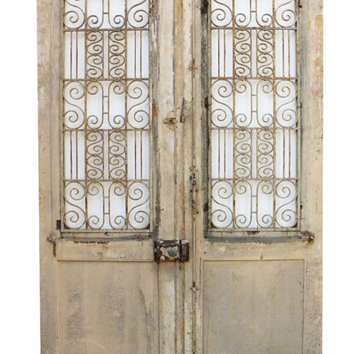 A Set Of Antique Exterior Doors With Iron Grills
