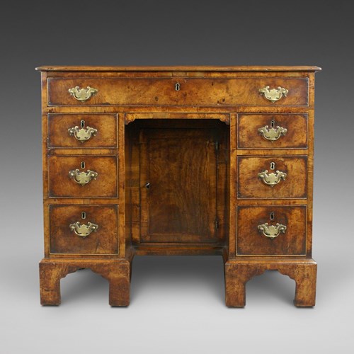 A George II Walnut Knee Hole Desk