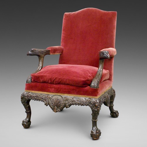 A superb carved library arm chair