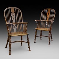 A matched pair of yew wood arm chairs